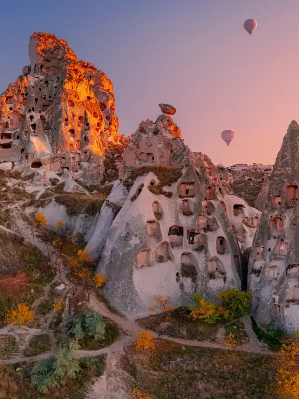 Uchisar Castle with Hot Air Balloons in Cappadocia, Turkey