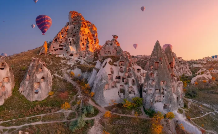 Uchisar Castle with Hot Air Balloons in Cappadocia, Turkey