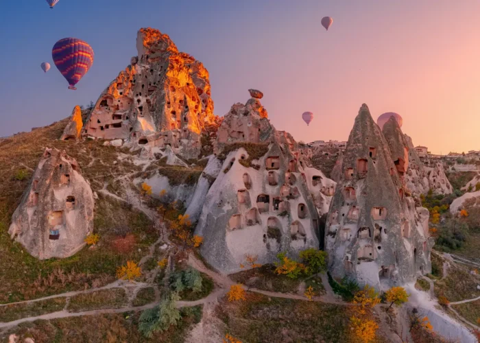 Uchisar Castle with Hot Air Balloons in Cappadocia, Turkey