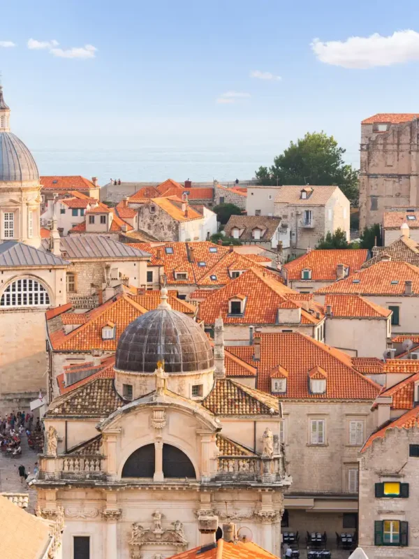 Dubrovnik old town cityscape with cathedral and red roofs.