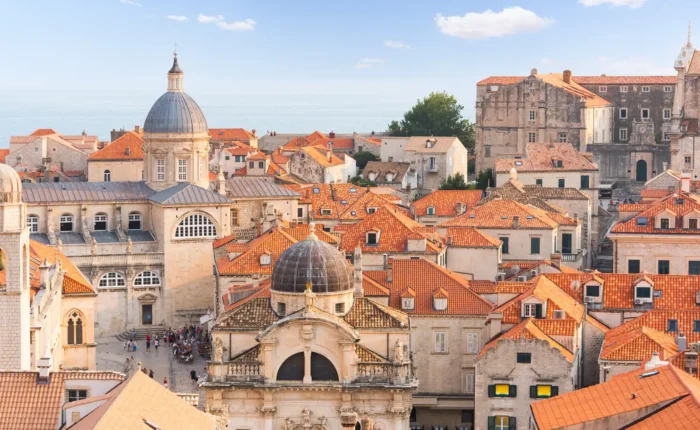 Dubrovnik old town cityscape with cathedral and red roofs.