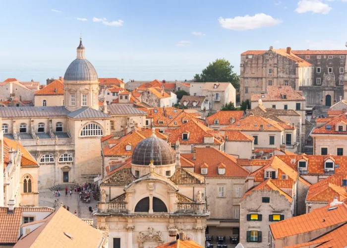 Dubrovnik old town cityscape with cathedral and red roofs.