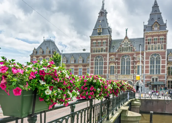 Pink And White Petunias Decorating A Bridge With The Rijksmuseum, Amsterdam, Netherlands