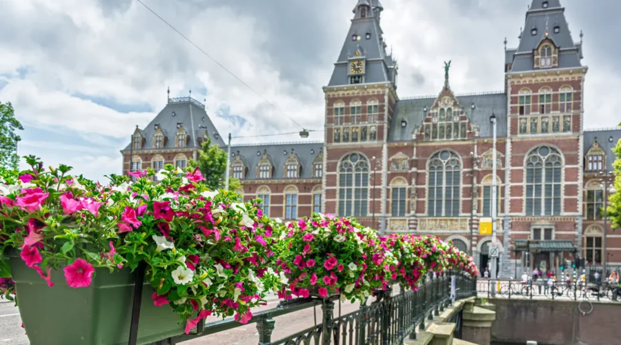 Pink And White Petunias Decorating A Bridge With The Rijksmuseum, Amsterdam, Netherlands