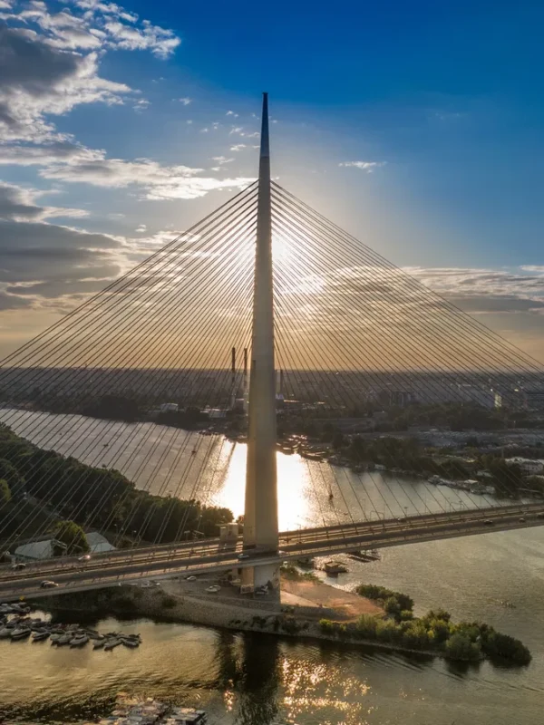 A huge metal bridge across a wide river in Belgrade, Serbia