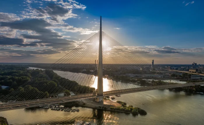 A huge metal bridge across a wide river in Belgrade, Serbia