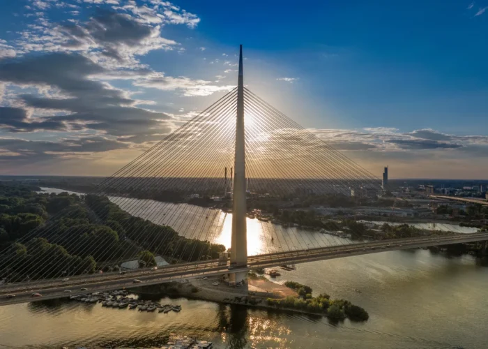 A huge metal bridge across a wide river in Belgrade, Serbia